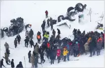  ?? YILMAZ SONMEZ/ASSOCIATED PRESS ?? Emergency service members work in the snow Wednesday around overturned vehicles near the town of Bahcesaray in eastern Turkey. An avalanche slammed into a mountain road, wiping out a huge team of rescue workers sent to find people missing in an earlier avalanche.