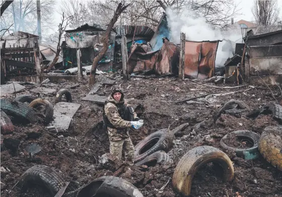  ?? Picture: AFP ?? A police officer inspects a hole after a rocket strike in Kramatorsk in the Ukraine. At least three people were killed in attacks there.