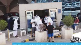  ??  ?? KUWAIT: People queue outside money exchange offices and bank branches in Kuwait on Tuesday. —Photos by Fouad Al-Shaikh