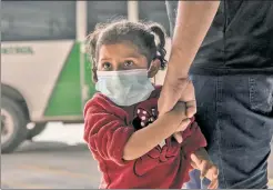  ??  ?? MAJOR MINOR ISSUE: This migrant child arrives in the US with her family, but the border could be flooded with unattended kids this year.