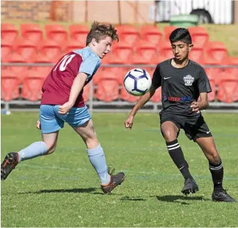  ??  ?? BEST OF SPORT: St Albans River Peasley (left) and West Wanderers Wahoos player Paul Jacob compete for possession during the Toowoomba Football League under 14/15A final. The Chronicle is looking for the region’s best junior soccer coach.