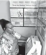  ?? Chris Tomlinson / Houston Chronicle ?? Yolanda Jackson, human resources manager at Milstead Automotive, has a checkup at a kiosk provided by Kelsey-Seybold’s physicians’ group.