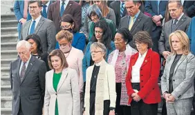  ?? SAUL LOEB AFP VIA GETTY ?? Members of the U.S. Congress and the Episcopal bishop of Washington, Mariann Edgar Budde, hold a moment of silence Thursday in Washington to recognize the one million people who have died as a result of COVID-19 in the U.S.