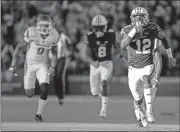  ??  ?? Butch Dill / The Associated Press
Auburn wide receiver Eli Stove (12) breaks away for a touchdown against Arkansas during the first half of Saturday’s in Auburn, Ala.