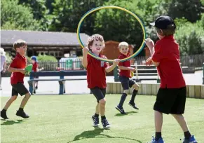  ?? — reuters ?? Keeping the distance: Children playing on the grounds of a primary school in Britain where some schools have reopened amid the Covid-19 outbreak.