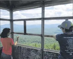  ?? Herb Terns / Times Union ?? Outdoors writer Gillian Scott and her daughter visited the cab of the fire tower on Stillwater Mountain in Old Forge recently.