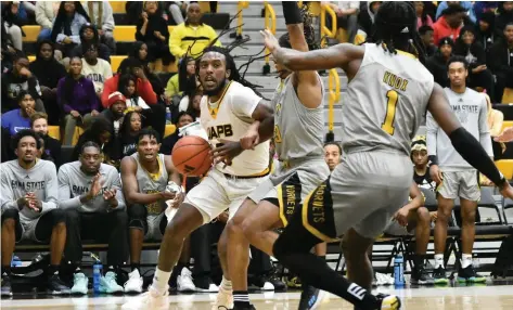  ?? (Pine Bluff Commercial/I.C. Murrell) ?? Rashad Williams of UAPB attacks the baseline against C.J. Hines (3) and Amarr Knox of Alabama State in the first half Monday at H.O. Clemmons Arena.