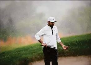  ?? Nick Wass / Associated Press ?? Jason Day lines up a shot in the rain on the 16th hole during the second round of the Wells Fargo Championsh­ip at TPC Potomac at Avenel Farm in Potomac, Md., on Friday.