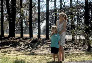  ?? IAIN MCGREGOR/ STUFF ?? Rebecca Ashman with daughter Aurelia, 6, at their home in West Melton, which had been under threat as a hedge and trees burned, destroyed by fireworks on November 3.