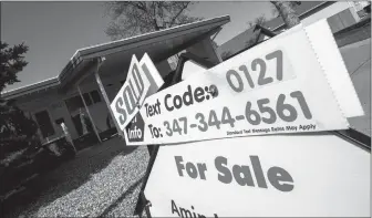  ?? Herald photo by Ian Martens ?? A real estate sign marks a house as sold on the city’s southside. The local real estate market was having another solid year prior to the COVID-19 pandemic. @IMartensHe­rald