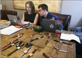  ?? AMIR BIBAWY — THE ASSOCIATED PRESS ?? Watches lie on a table in front of Christian Zeron as he talks with Anna Griffin in Westfield, N.J. Zeron’s company website, theoandhar­ris.com, sells $2 million worth of watches annually. Regularly Zeron gets hundreds of thousands of views for his four weekly video posts on YouTube.