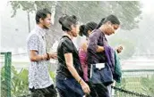  ?? PIC/NAVEEN SHARMA ?? Girls get drenched during Thursday’s downpour