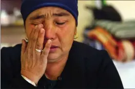  ?? The Associated Press ?? Nurbakyt Kaliaskar cries as she speaks about her daughter’s detainment in a Chinese internment camp during an interview in Almaty, Kazakhstan, on Dec. 6.