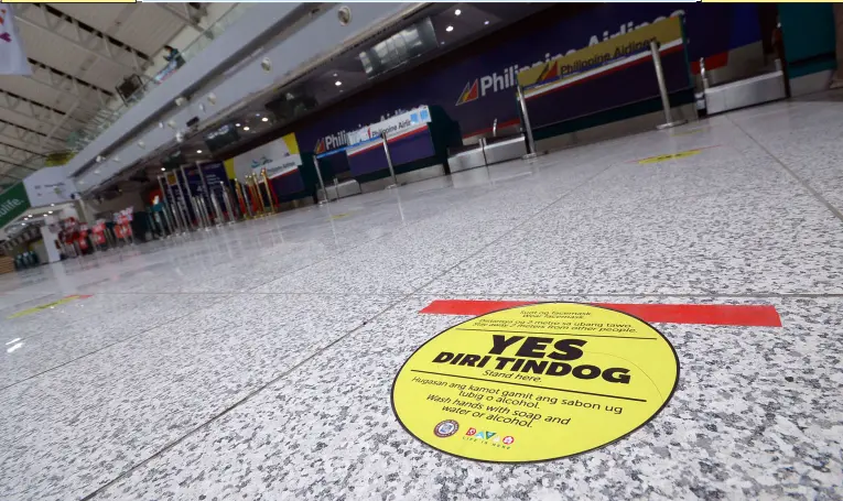  ??  ?? AS THE CITY adjusts to the new normal, the floor of the Francisco Bangoy Internatio­nal Airport is marked with yellow stickers to ensure that passengers checking in for their flights maintain social distancing. BING GONZALES