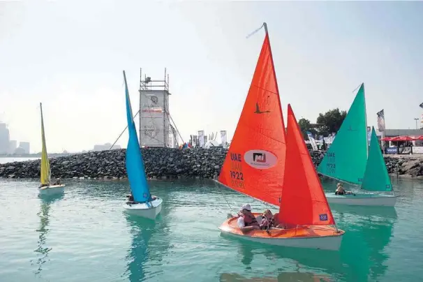  ?? Sarah Dea / The National ?? Sailabilit­y, a non-profit volunteer organisati­on that helps disabled people sail, offers festivalgo­ers a taste of the sea with trial runs in access dinghies at Destinatio­n Village.