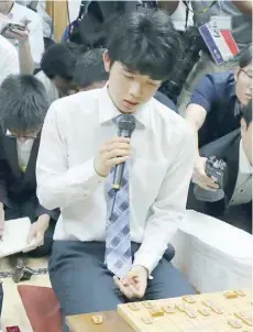  ?? — AFP ?? Junior high school student Sota Fujii, 14, speaking in Tokyo after breaking a 30-year-old record with his 29th straight win in the game known as shogi.