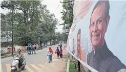  ??  ?? A political poster features an image of Hindu politician Jayant Sinha, who draped garlands on eight men convicted of Ansari’s death.