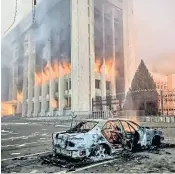  ?? ?? A burnt car is seen outside the mayor’s office in Almaty after protesters broke into the building and set it on fire. Protests across Kazakhstan were prompted by a doubling in fuel prices