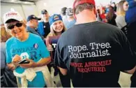  ?? PHOTOS BY JONATHAN ERNST/REUTERS (LEFT); STAFF FILE PHOTO (RIGHT) ?? Though journalism bashing is all the rage — especially among some Trump supporters who choose to wear “Rope. Tree. Journalist.” shirts, left — think of Sentinel reporter Steve Hudak, right, who has covered small towns, local wildlife and human-interest...