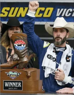  ?? LARRY PAPKE — THE ASSOCIATED PRESS ?? Jimmie Johnson celebrates victory lane in front of the trophy after winning the NASCAR Cup Series auto race at Texas Motor Speedway in Fort Worth, Texas, Sunday.