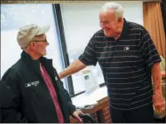  ?? RYAN MICHALESKO — THE DALLAS MORNING NEWS VIA AP ?? Retired Major League Baseball umpire Larry Barnett, right, who has visited hospitaliz­ed veterans since 1977, presents a jacket to Russell Moore, a Navy veteran, during a visit to the VA North Texas Health Care System on Thursday in Dallas. “Sometimes people here have no one to come see them. They have no friends, no family,” Moore said. “It’s important to have people like Larry stop by and come see us.”