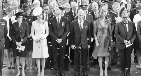  ??  ?? May (left), Prince William and Catherine, King Philippe (third right) and Queen Mathilde watch as poppies are dropped from the roof of the Menin Gate in Ypres for the official commemorat­ions marking the 100th anniversar­y of the Battle of Passchenda­ele....