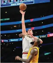  ?? Ashley Landis/Associated Press ?? Denver Nuggets center Nikola Jokic shoots over Los Angeles Lakers forward LeBron James in the second half of Game 4 of the Western Conference finals on Monday in Los Angeles.