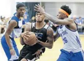  ?? JOHN RAOUX/ASSOCIATED PRESS ?? Orlando’s Marcus Georges-Hunt drives to the basket against New York’s Damyean Dotson, left, and Jamel Artis.