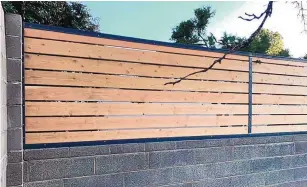  ??  ?? Horizontal wood fencing can be placed atop brick walls.