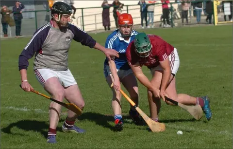  ??  ?? Liam Mellows goalkeeper Mark Kennedy and Patsy McGlynn combine to thrwart Fiachra Hourihane of Oylegate-Glenbrien.