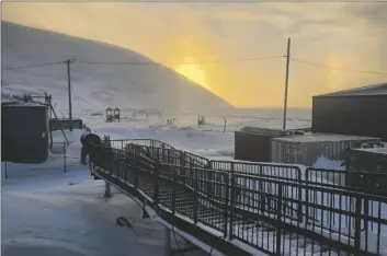  ?? CHRISSY FRIBERG VIA AP ?? A walkway leading into the school in Wales, Alaska, where a 24-year-old woman and her 1-year-old son were killed in an encounter with a polar bear, on Jan. 17.