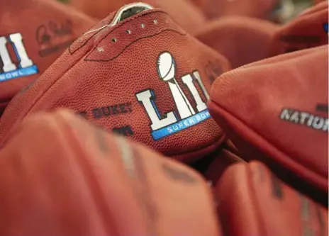  ?? RICK OSENTOSKI/ASSOCIATED PRESS ?? Official footballs for Super Bowl LII are on sale. The Philadelph­ia Eagles will play the defending champion New England Patriots in Minneapoli­s on Feb. 4.