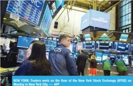  ??  ?? NEW YORK: Traders work on the floor of the New York Stock Exchange (NYSE) on Monday in New York City.