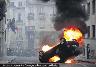 ?? EFE / IAN LANGSDOM AFP / ALAIN JOCARD ?? Un cotxe cremant a l’avinguda Marceau de París.
