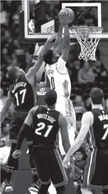  ??  ?? Miami Heat guard Rodney McGruder attempts to block the shot of Nuggets guard Emmanuel Mudiay on Wednesday night at the Pepsi Center. Matthew Stockman, Getty Images