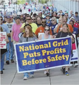  ?? STAFF PHOTOS BY ANGELA ROWLINGS ?? SOLIDARITY: Locked out National Grid workers march yesterday to support striking hotel workers at the Sheraton.