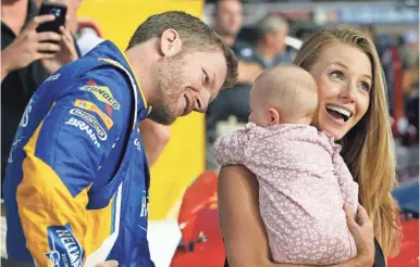  ?? STEVE HELBER/AP ?? Dale Earnhardt Jr. plays a big role in taking care of daughter Isla with his wife, Amy. “I want to do it because you love her so much and you want to be around her,” he says.