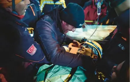  ?? ISMAIL COSKUN/IHA ?? Rescue workers carry survivor Kamil Can Agdas to an ambulance Saturday in Kahramanma­ras, Turkey.