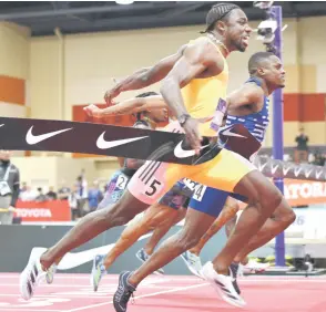  ?? — AFP photo ?? Lyles (left) defeats Coleman to win the Men’s 60m Dash Final during the 2024 USATF Indoor Championsh­ips at the Albuquerqu­e Convention Centre in Albuquerqu­e, New Mexico.