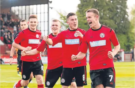  ?? Picture: SNS. ?? Elliot Ford, right, celebrates with his team-mates after opening the scoring.