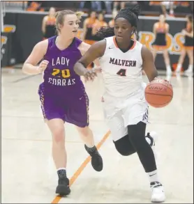  ?? The Sentinel-Record/Mara Kuhn ?? DRIVING THE LANE: Fountain Lake’s Jillian Norman (4) drives the ball as Malvern’s Tiffany Monk (1) defends during Thursday’s basketball game at Malvern’s Leopard Center. The Lady Leopards pulled away for a 43-40 win.