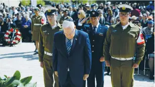  ?? (Amir Cohen/Reuters) ?? PRESIDENT REUVEN RIVLIN lays a wreath during a ceremony at Yad Vashem on Holocaust Remembranc­e Day yesterday.