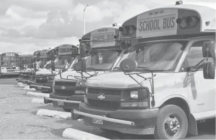  ?? IRIS SAMUELS/AP ?? School buses pack a lot Friday ahead of the school year in Helena, Mont. Districts across the country are coping with a shortage of bus drivers.