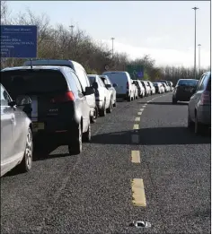  ??  ?? Cars parked along the M1 Dundalk South interchang­e.