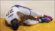  ?? MARCIO JOSE SANCHEZ — THE ASSOCIATED PRESS ?? LeBron James holds his ankle after going down with an injury during the first half against the Hawks on March 20 in Los Angeles.