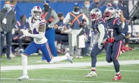  ?? AP ?? Bills wide receiver Stefon Diggs scores a touchdown as Patriots defensive backs Jonathan Jones and J.C. Jackson, right, look on during Monday’s loss.