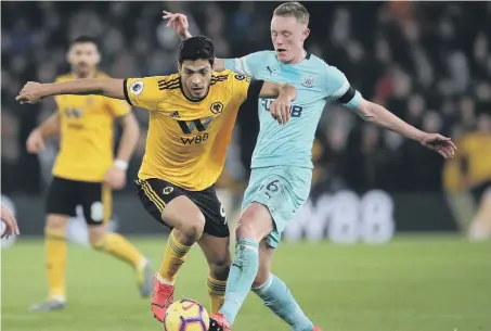  ??  ?? Newcastle’s Sean Longstaff takes on Wolves’ Raul Jimenez.