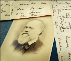  ?? Peter Macdiarmid/Getty Images North America/TNS ?? Original letters from Charles Darwin are displayed at the Herbaruim library in 2009, at the Royal Botanic Gardens, Kew in London. Darwin wrote the letter, right, to his mentor Reverend John Henslow aboard HMS Beagle in April 1833 — writing two ways — as paper was expensive.