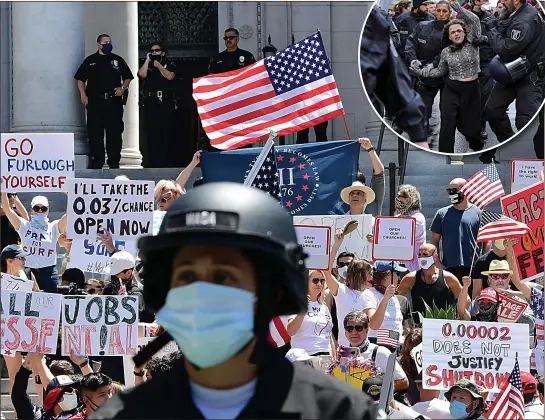  ??  ?? FACE OF AMERICA: A policeman protects himself as crowds rage against the lockdown in Los Angeles. Inset, Berlin yesterday