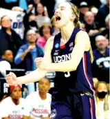  ?? AP PHOTO/FRANK FRANKLIN II ?? Connecticu­t guard Paige Bueckers reacts in double overtime against N.C .State during the East Regional final on Monday in Bridgeport, Conn. UConn won 91-87.